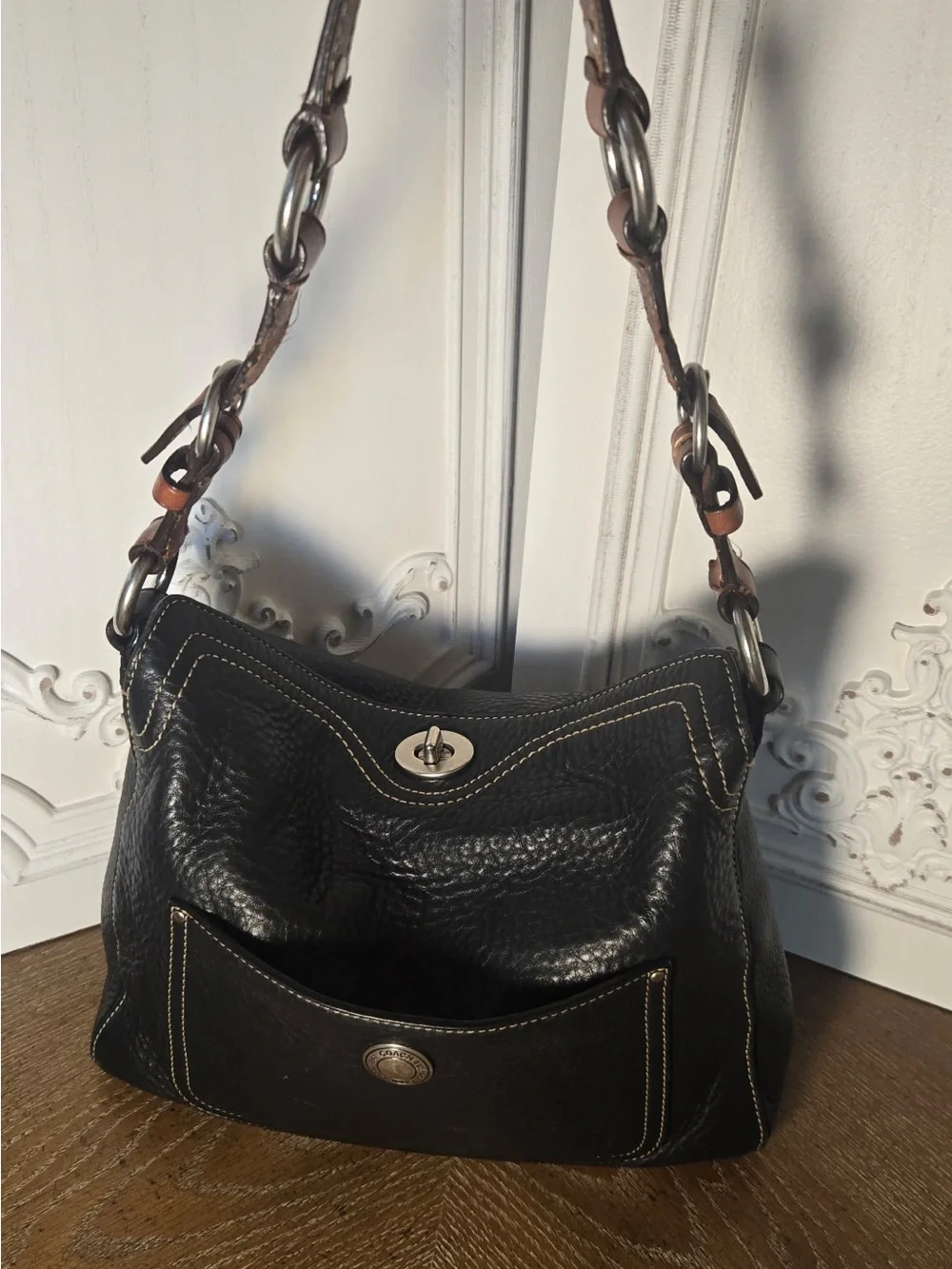Coach Black Pebbled leather Chelsea turnlock top.